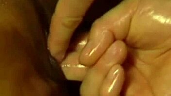 An asian babe gives an interracial blowjob while receiving a sensual massage and handjob from her lover