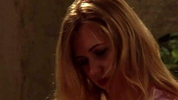 Busty maid in lingerie relaxes with a pillow