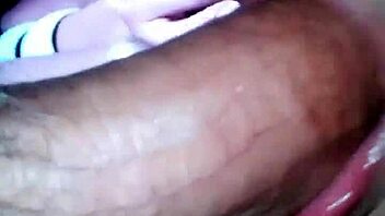 A busty shemale enjoys giving deepthroat and receiving a big cock in a gloryhole setting