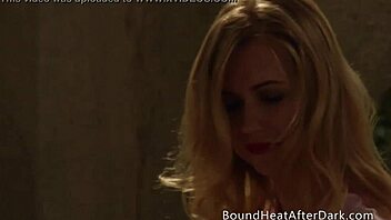 Busty maid in lingerie relaxes with a pillow