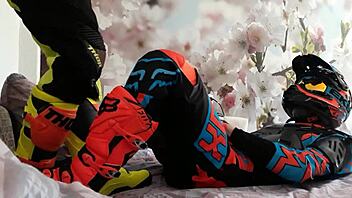 motocross biker in costumes treads boots suggestively