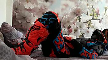 motocross biker in costumes treads boots suggestively