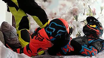 motocross biker in costumes treads boots suggestively