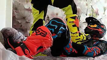 motocross biker in costumes treads boots suggestively