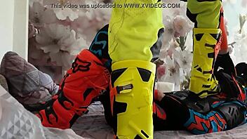 motocross biker in costumes treads boots suggestively