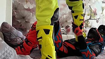 motocross biker in costumes treads boots suggestively