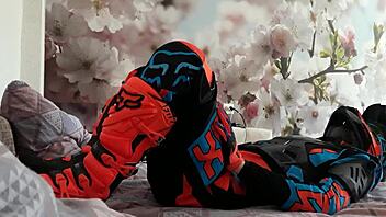 motocross biker in costumes treads boots suggestively