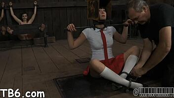 Bound slut in femdom bondage sucking cock.