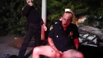Two gay cops suck and ride big black cock outdoors.