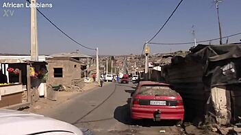 ebony women engage in playful strap-on activities and enjoy eating fruit.