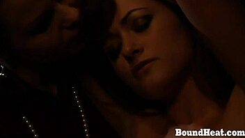betrayed cargo lesbian tied in chains and groped by the dominant madame in this femdom scene