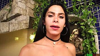 Beautiful brunette trans woman strokes her big cock gently.