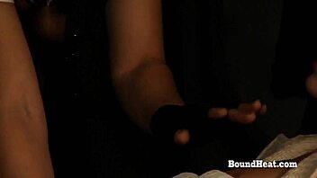 betrayed cargo lesbian tied in chains and groped by the dominant madame in this femdom scene