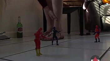 A tall blonde in heels and costumes enjoys her toys and balloons