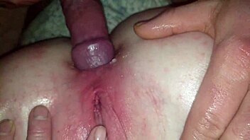 A couple engages in anal sex.