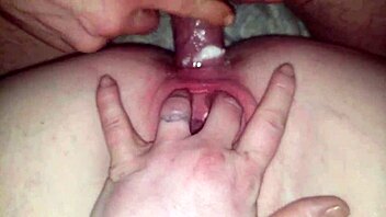 A couple engages in anal sex.