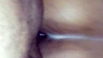 Black woman bends over to receive a facial from her partner
