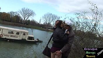 A young girl performs oral sex on an older man