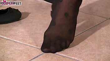 In Black Dotted Stockings Plays With Her Feet