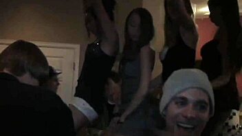 Coed lesbians tease and dildo each other at university party while everyone watches