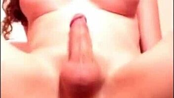 the tranny is fucking her ass with a dildo hard