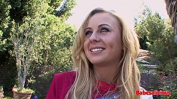 Blonde cheerleader gets fucked outdoors by two guys.