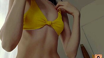 petite girl trying on bikini for summer fun