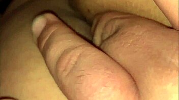 Nicholas performs striptease at night club, ripping tight clothes to expose pussy while dancing seductively.