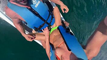 Brunette gets a deepthroat blowjob and rides big cock on a jetski