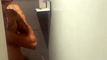 Gay guys cruise in gym shower for blowjobs and masturbation.