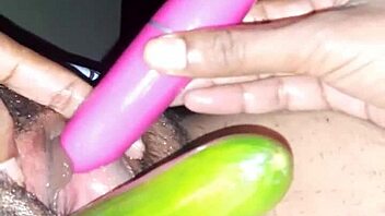 Beautiful Indian woman enjoying sex toys and cucumber on her oiled up body