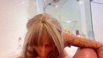 A blonde milf gives a rough blowjob with a bathroom POV camera angle.