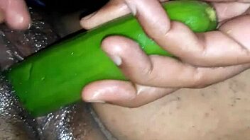Beautiful Indian woman enjoying sex toys and cucumber on her oiled up body