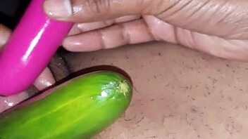 Beautiful Indian woman enjoying sex toys and cucumber on her oiled up body