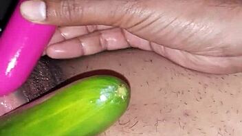 Beautiful Indian woman enjoying sex toys and cucumber on her oiled up body
