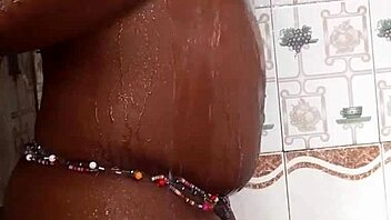 ebony woman fucking herself in the bathroom with intense pleasure