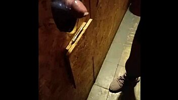 She sucks cock through the GLORY HOLE