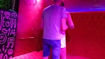 Blonde babe with small tits gives handjob to stranger in bar while cuckold husband films.