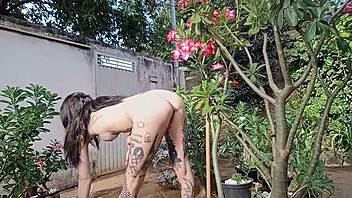 Tattooed woman fully naked showing off her hairy pussy and big ass.