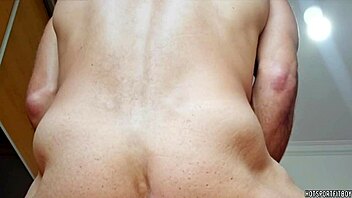 A handsome man has sex with a Fleshlight at the window and cums inside it