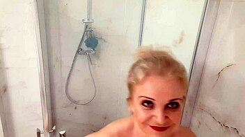 older blonde with huge boobs enjoys a hot shower