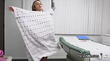 Doctor examining a pregnant woman with implants in her breasts in the office