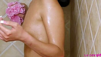 Beautiful brunette gets some hot water for a steamy scene