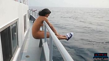 exotic playboy model strips naked on a sunny boat ride