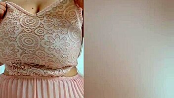 Young cutie in pink dress teases her big tits on camera