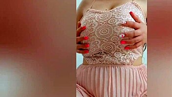 Young cutie in pink dress teases her big tits on camera