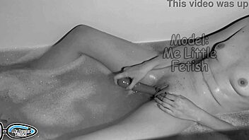 Slender girl enjoys evening bath, uses vibrator for relaxation and orgasm