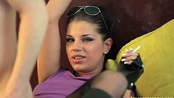 Angel Rivas smoking while using strap on