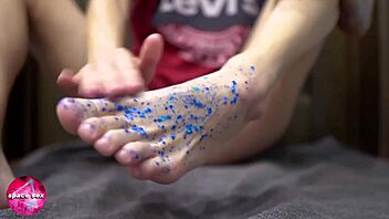 girl plays with glitters and gives footjob to big dildo