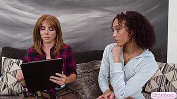 Redhead Lesbian Babe Devours Ebony Girlfriend’s Pussy While Client Watches in Awe.